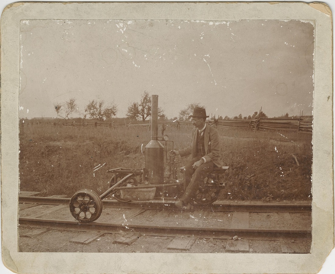 photograph of a man on a steam inspection car
