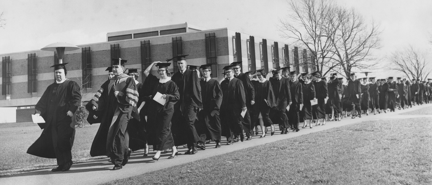 Students walk by the library for charter class graduation