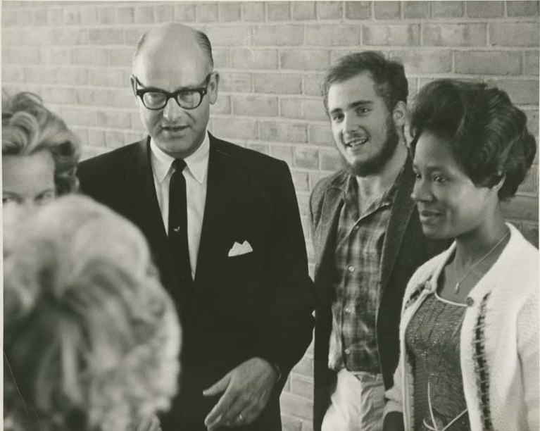 Photograph of Varner with students: one white, one black