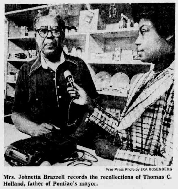 Johnetta Brazzell with tape recorder and microphone interviewing Thomas C. Holland.
