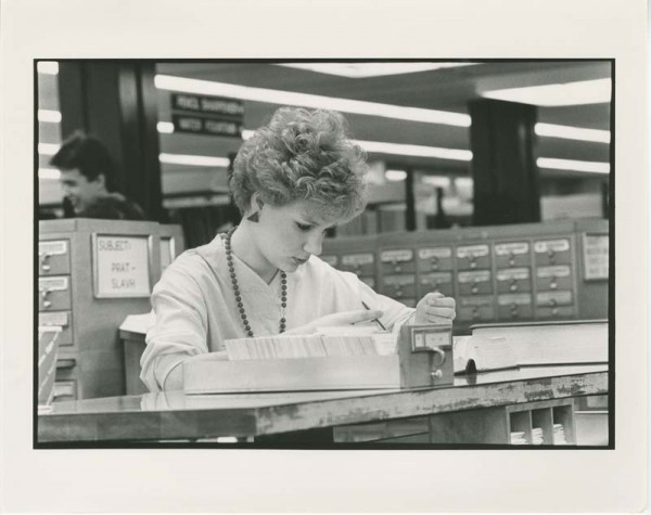 Student using library card catalogue